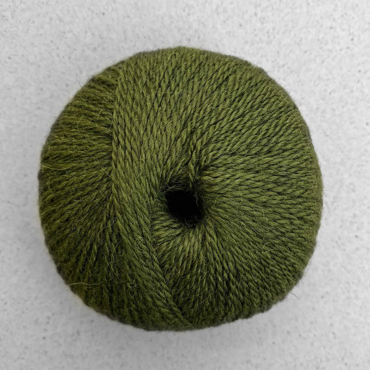 Ball of olive green Pascuali Balayage yarn.