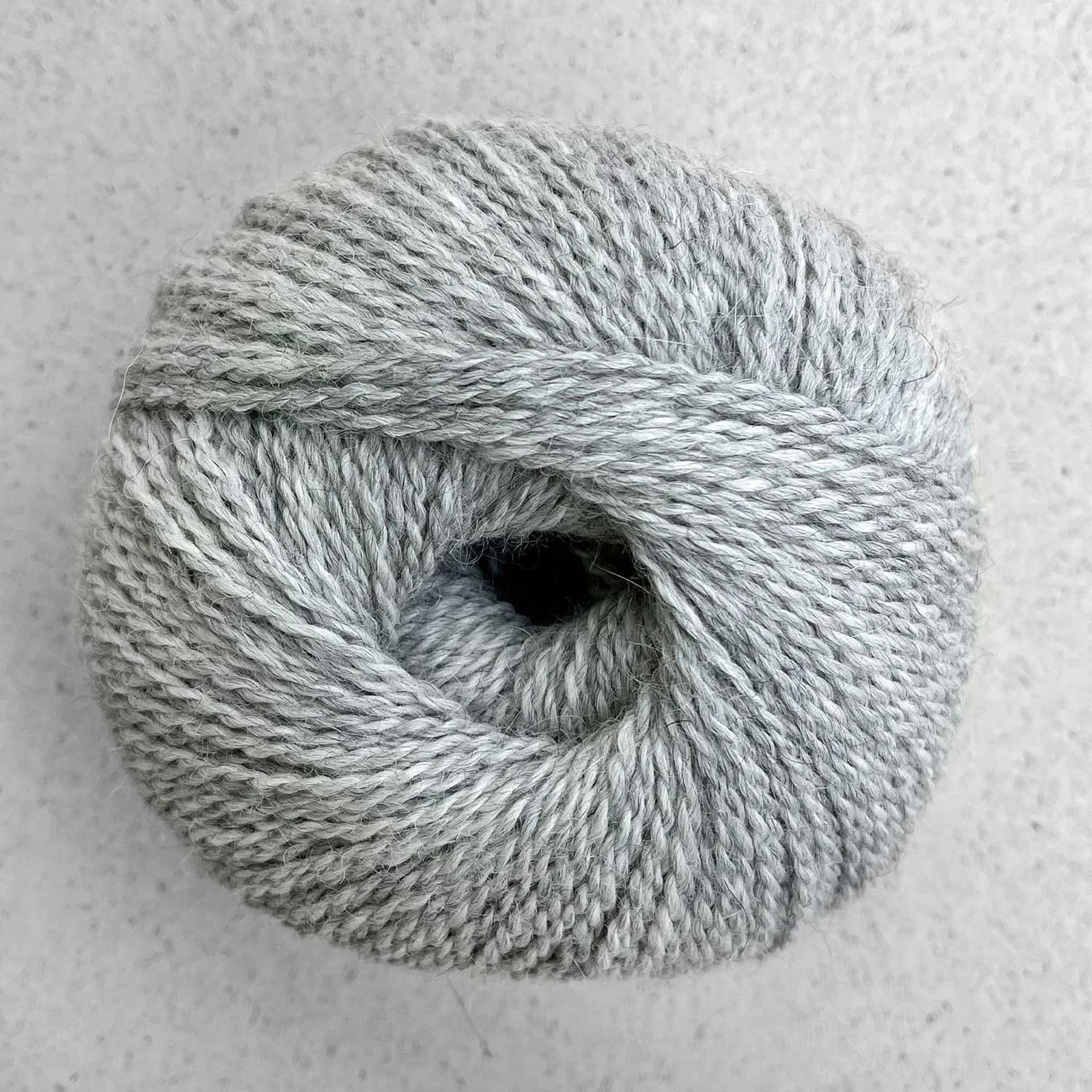 Ball of heathered gray Pascuali Balayage yarn.