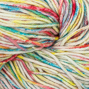 Close up on a speckled rainbow and cream skein of Cascade Nifty Cotton Splash yarn.