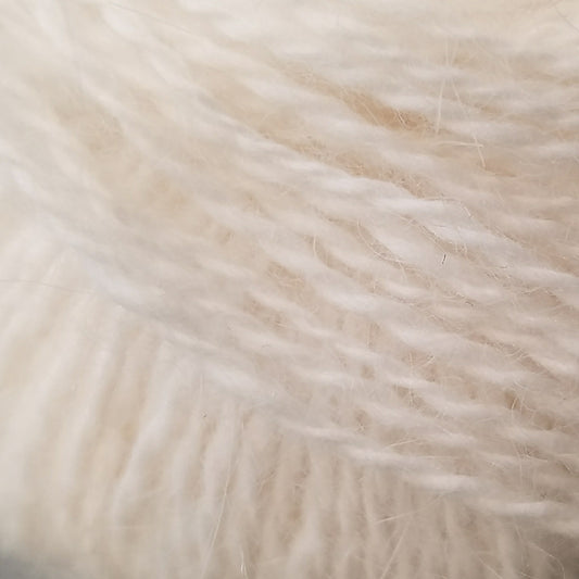 Close up on ball of natural white Plymouth Angora yarn.