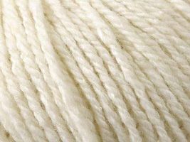 Close up on cream ball of Elsebeth Lavold Silky Wool XL yarn.