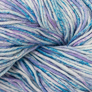 Close up on a speckled blue, purple and cream skein of Cascade Nifty Cotton Splash yarn.