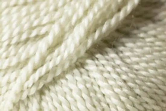 Close up on a ball of ivory Jo Sharp Alpaca Kid Lustre yarn.
