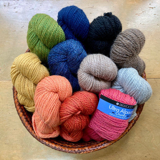 Basket full of colorful skeins of Berroco Ultra Alpaca Chunky yarn.
