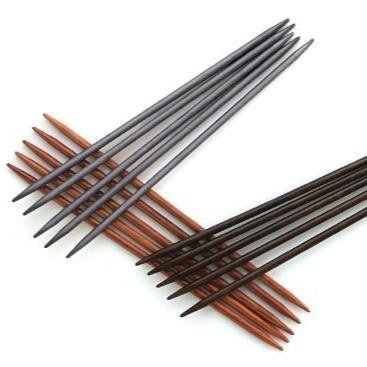 Three sets of five double pointed needles in shades of brown.