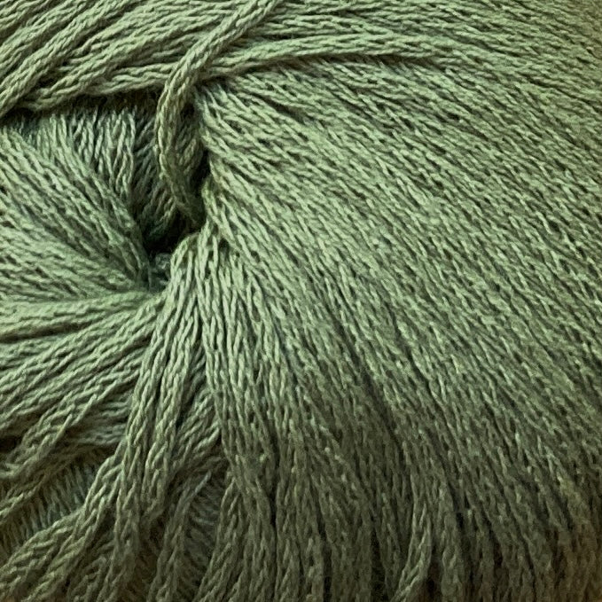 Close up on a grass green ball of M&K Eco Bomull yarn.