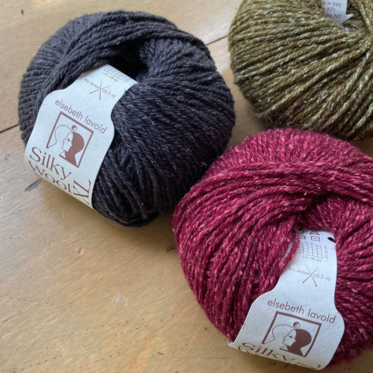 Several balls of Elsebeth Lavold Silky Wool XL yarn.