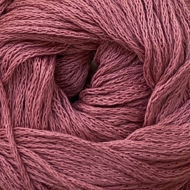 Close up on a brick red ball of M&K Eco Bomull yarn.