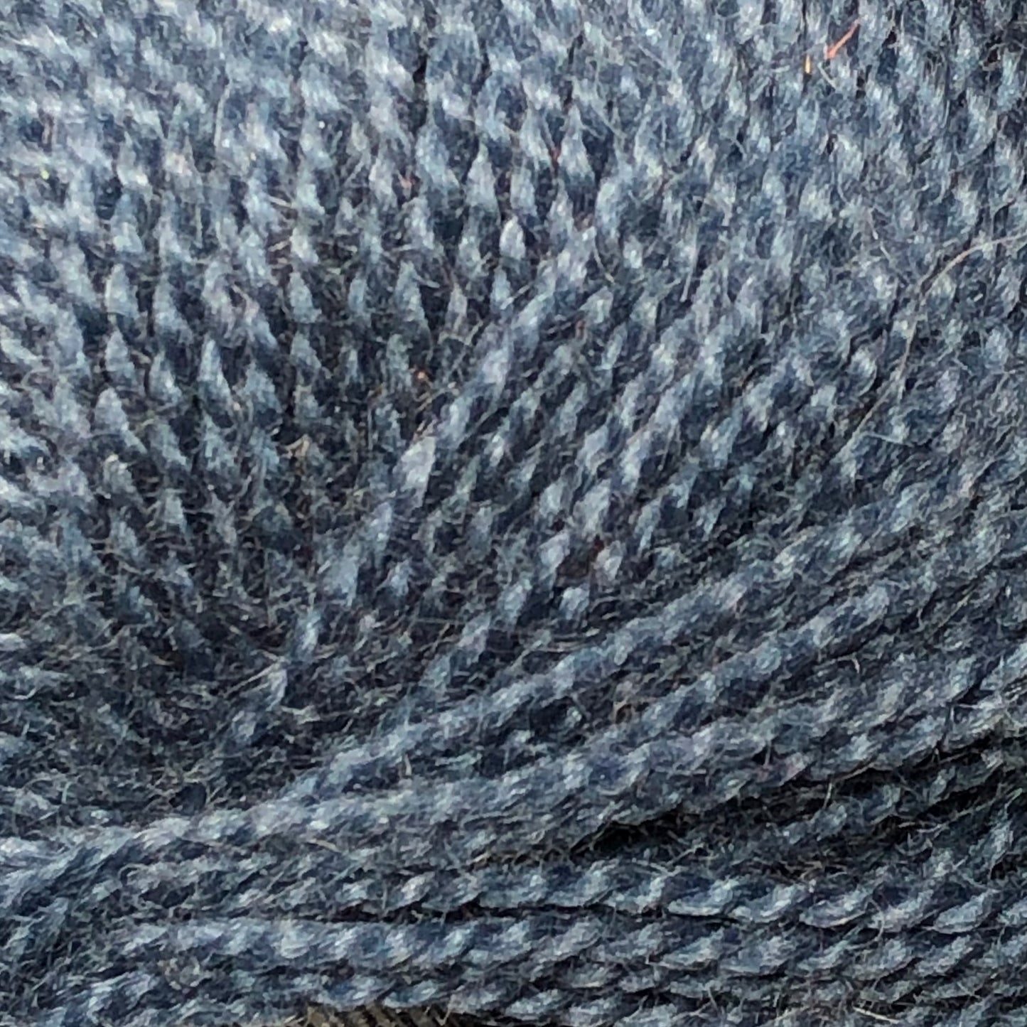 Close up on a ball of denim blue Jo Sharp Alpaca Kid Lustre yarn.