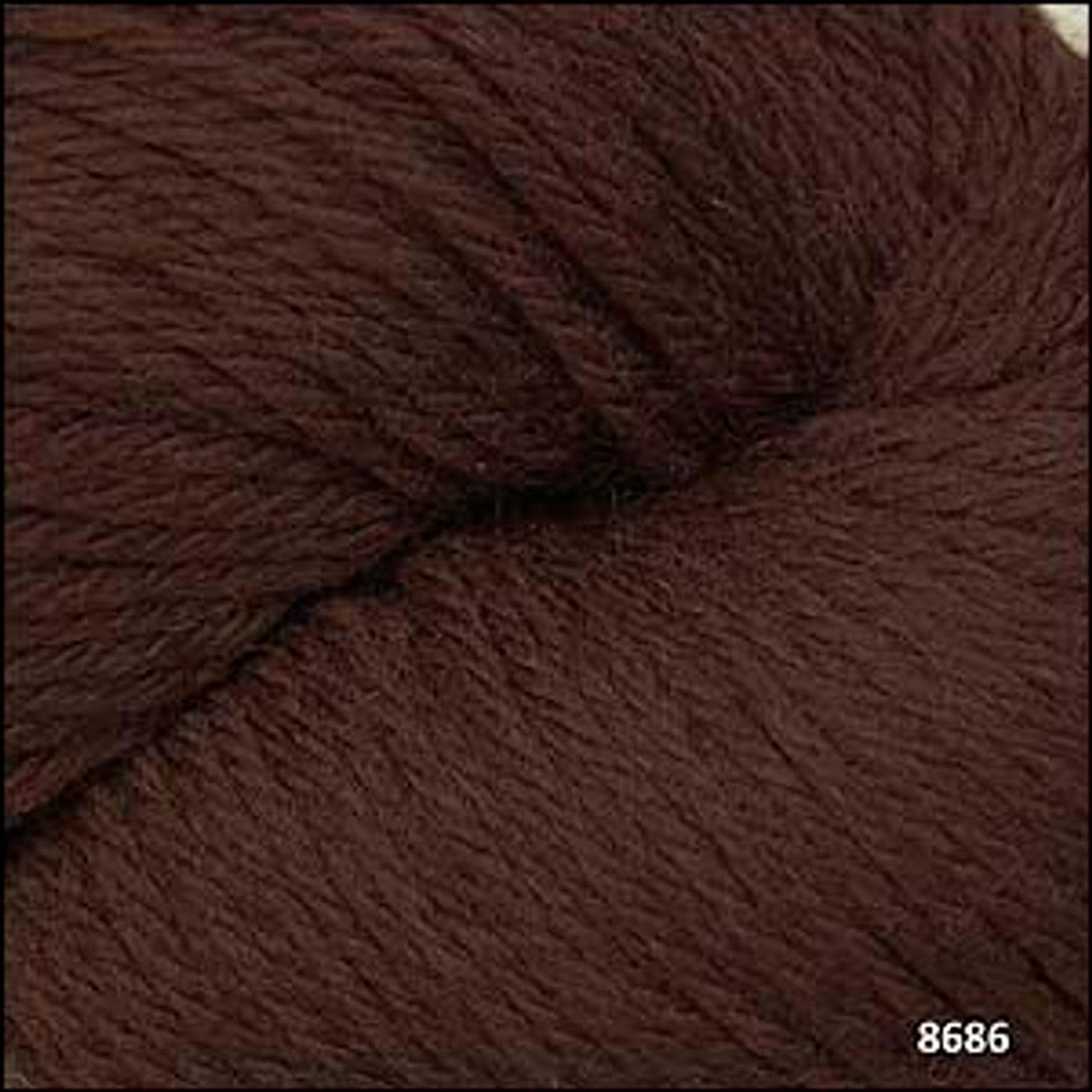 Close up on a chocolate brown skein of Cascade 220 Fingering yarn.