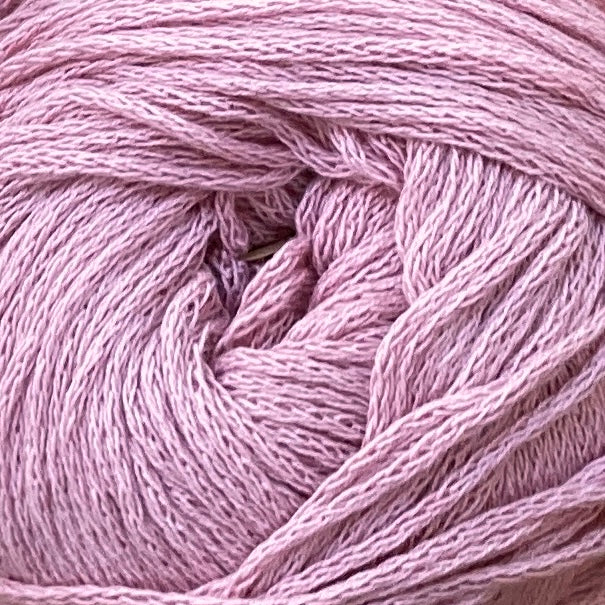 Close up on a light pink ball of M&K Eco Bomull yarn.