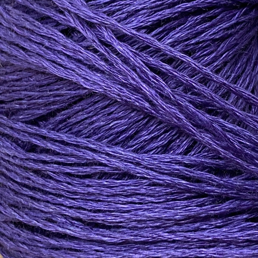 Close up on a purple ball of Katia Lino 100% yarn.
