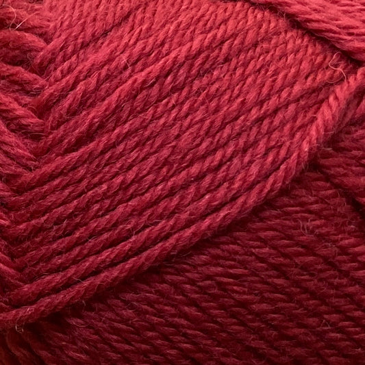 Close up on a red ball of Jo Sharp Classic Wool DK yarn.