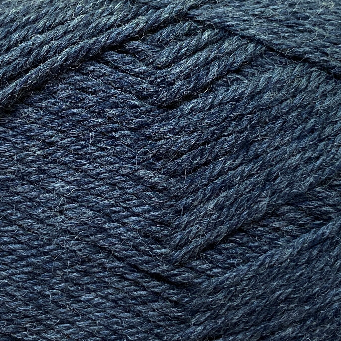 Close up on a dark gray ball of Jo Sharp Classic Wool DK yarn.