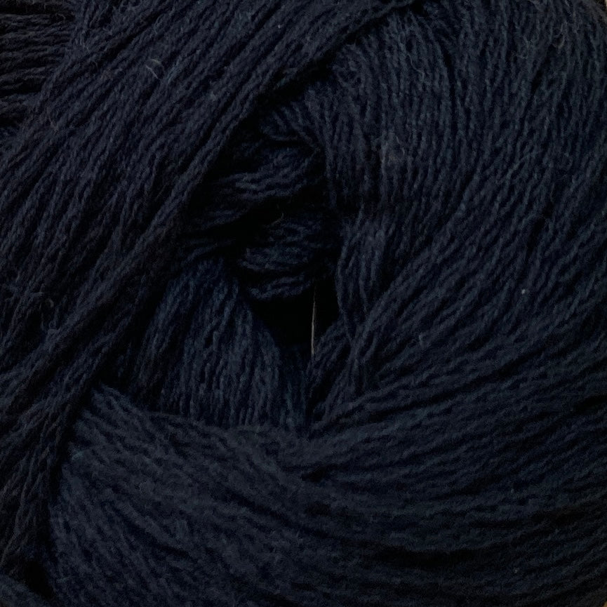 Close up on a black ball of M&K Eco Bomull yarn.