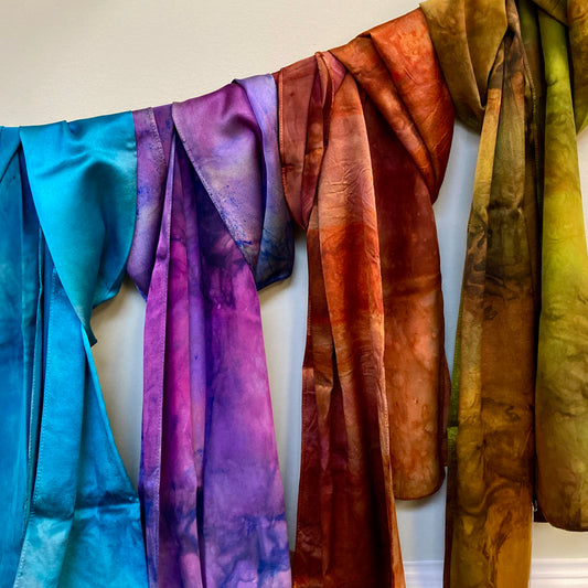 Colorful hand dyed silk wraps from Alchemy Yarns, on display at Hillsborough Yarn Shop