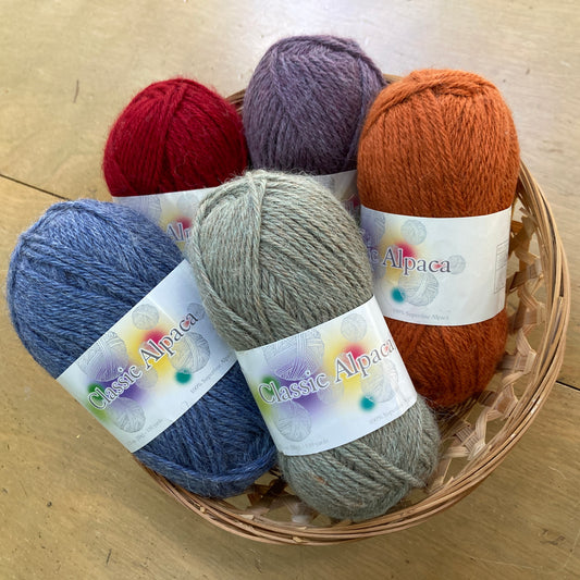 Basket of colorful balls of Alpaca Yarn Co. Classic Alpaca yarn.