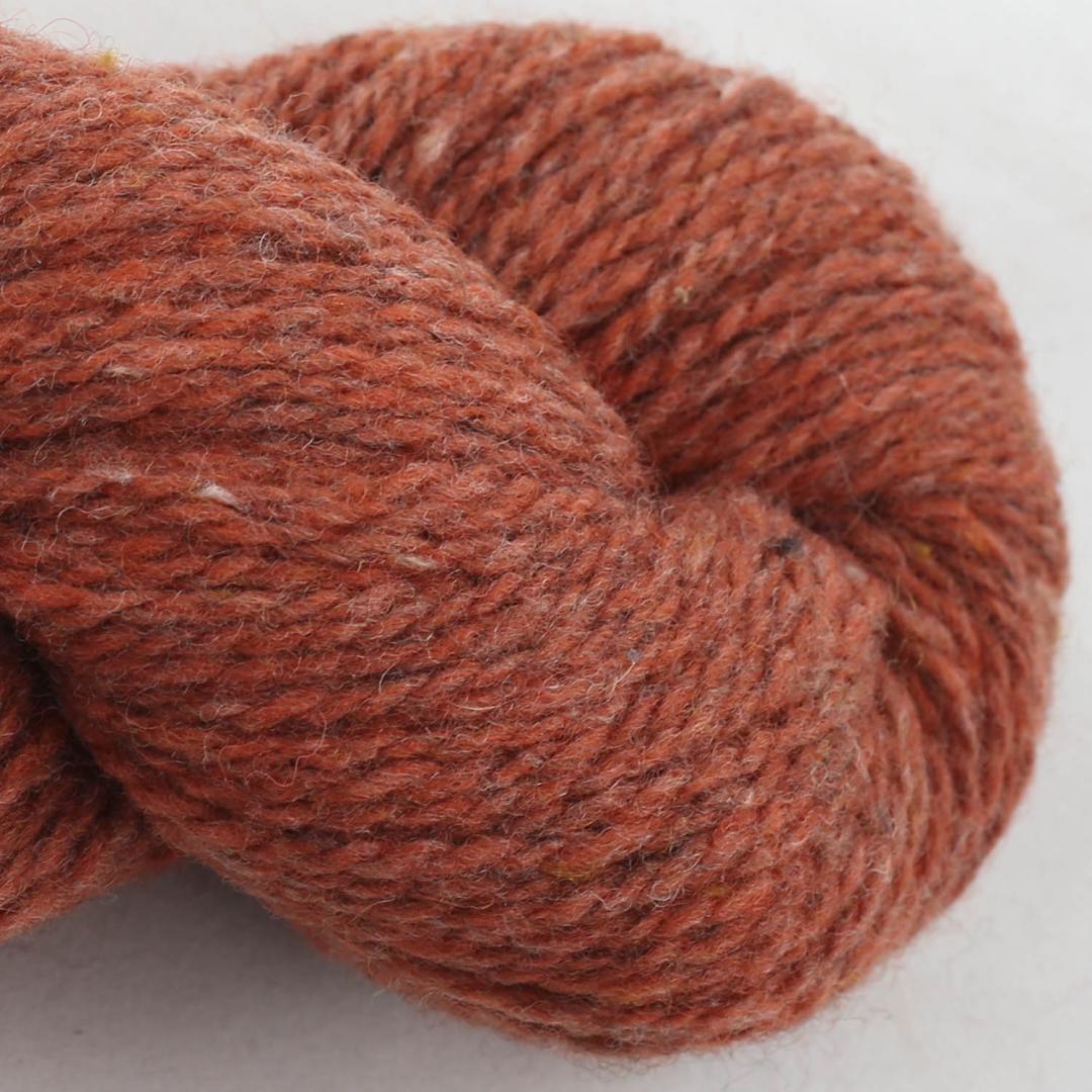 Close up on a pumpkin orange skein of BC Garn Loch Lomond yarn color 09.