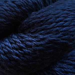 Close up on a skein of navy Cascade Baby Alpaca Chunky yarn.