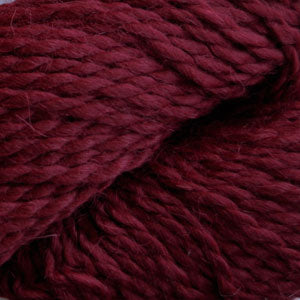 Close up on a skein of burgundy Cascade Baby Alpaca Chunky yarn.