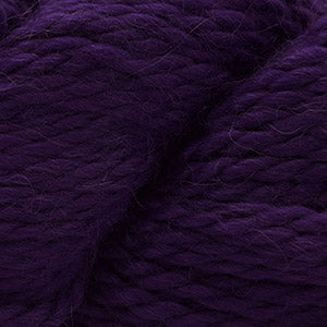 Close up on a skein of royal purple Cascade Baby Alpaca Chunky yarn.