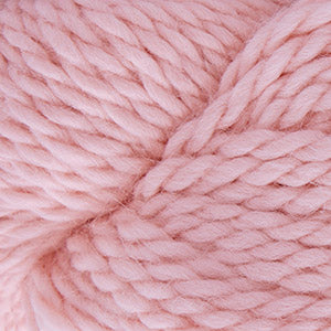 Close up on a skein of light pink Cascade Baby Alpaca Chunky yarn.