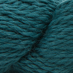 Close up on a skein of dark teal Cascade Baby Alpaca Chunky yarn.