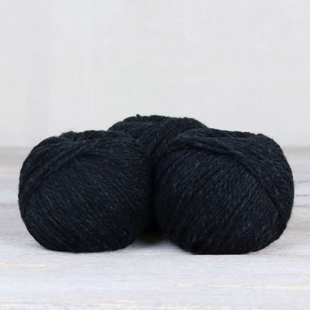 3 skeins of deep blue black Fibre Co. Lore yarn.