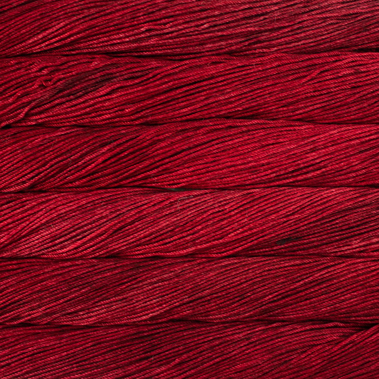 Skein of semisolid red Malabrigo Caprino yarn.