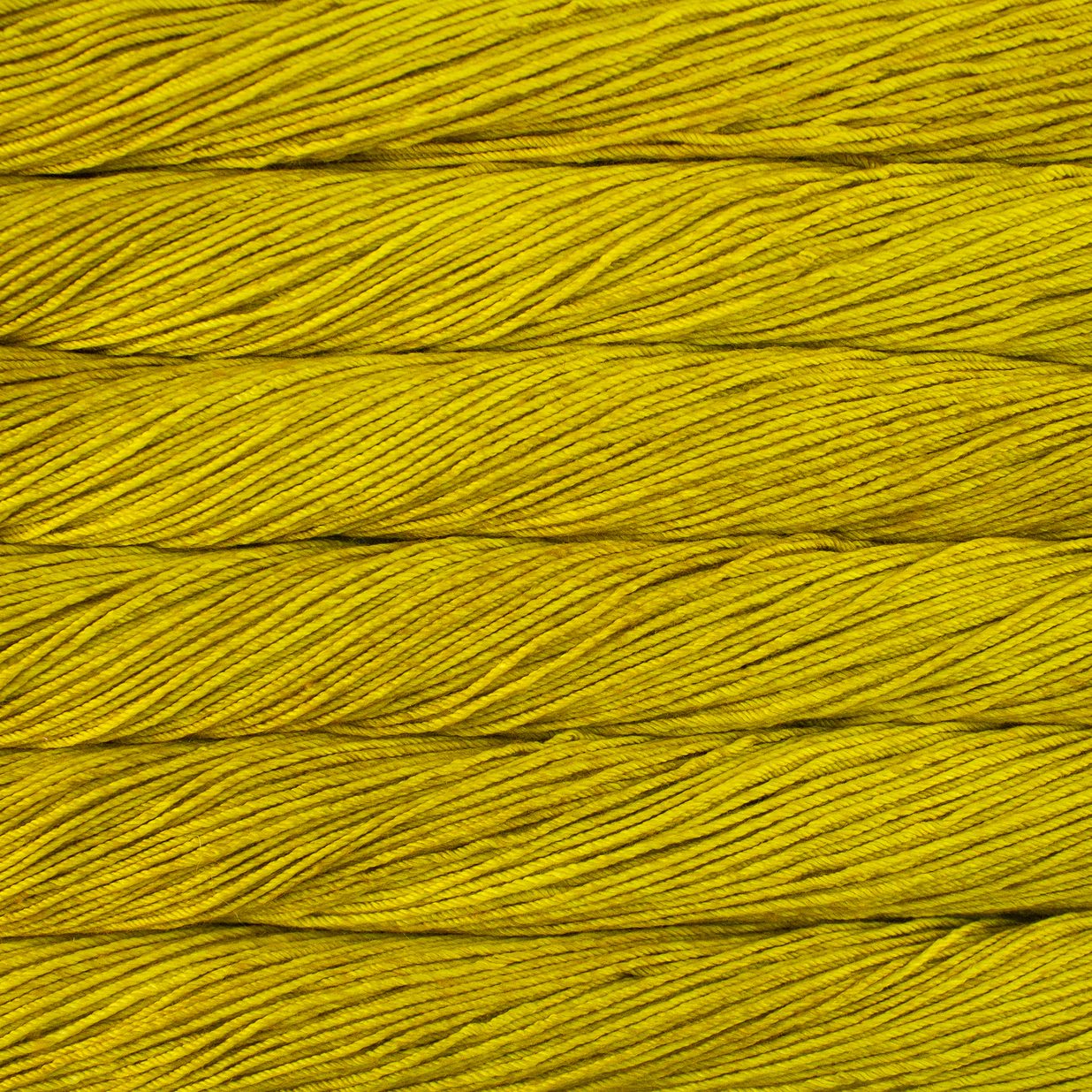 Skein of semisolid mustard yellow Malabrigo Caprino yarn.