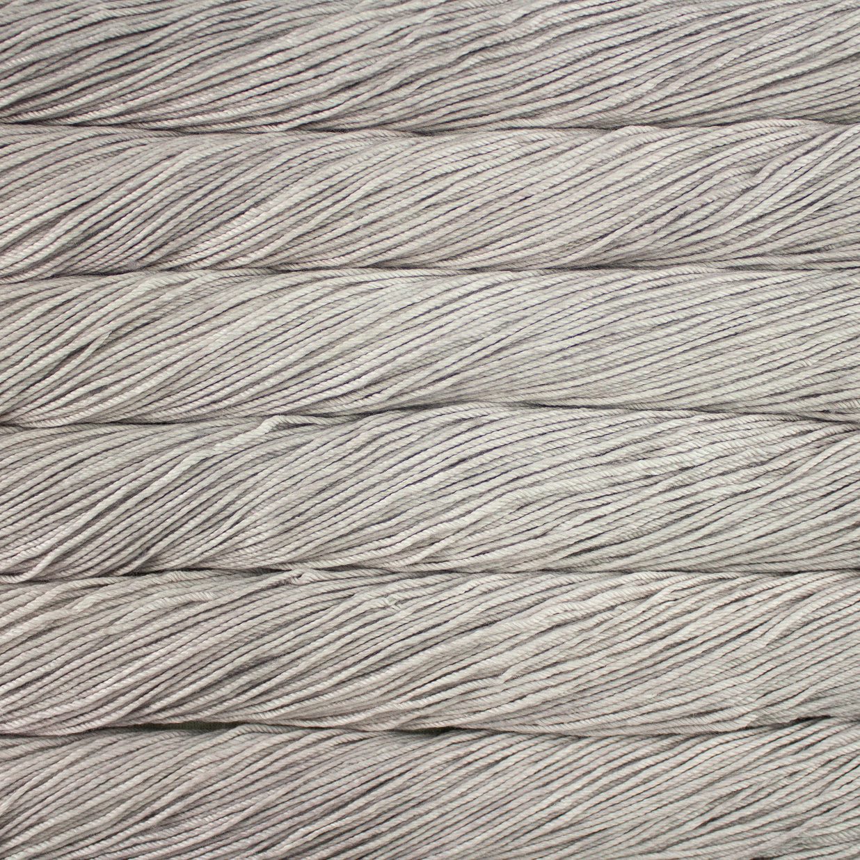 Skein of semisolid light beige Malabrigo Caprino yarn.