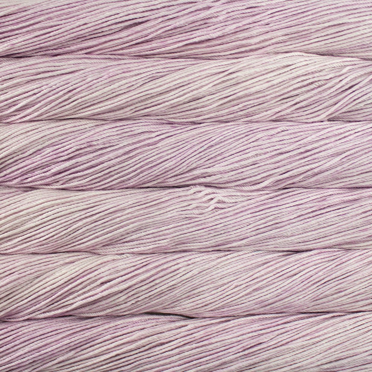 Skein of semisolid light pink Malabrigo Caprino yarn.