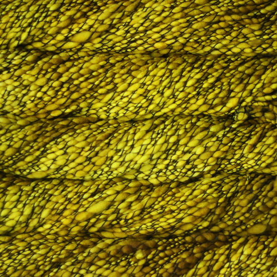 Skein of variegated mustard yellow Malabrigo Caracol yarn.