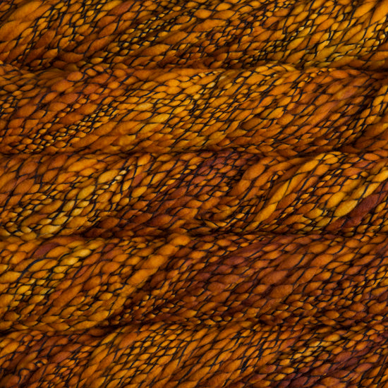 Skein of variegated orange yellow Malabrigo Caracol yarn.