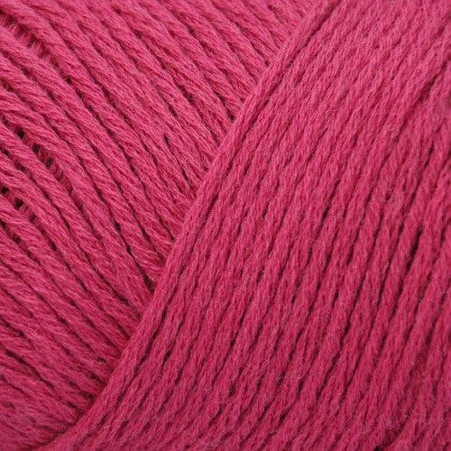 Close up on a red skein of Brown Sheep Cotton Fleece yarn.