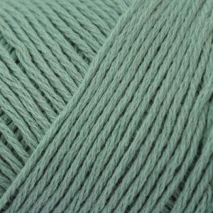 Close up on a light green skein of Brown Sheep Cotton Fleece yarn.