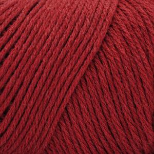 Close up on a dark red skein of Brown Sheep Cotton Fleece yarn.