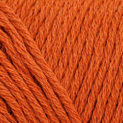 Close up on an orange skein of Brown Sheep Cotton Fleece yarn.