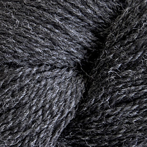 Close up on a dark heathered gray skein of Cascade 220 Fingering yarn.