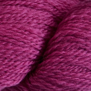 Close up on a cerise skein of Cascade 220 Fingering yarn.