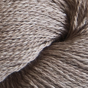 Close up on a light heathered brown skein of Cascade 220 Fingering yarn.