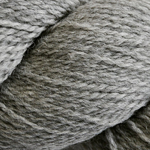Close up on a medium heathered gray skein of Cascade 220 Fingering yarn.