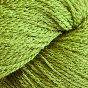 Close up on a grass green skein of Cascade 220 Fingering yarn.
