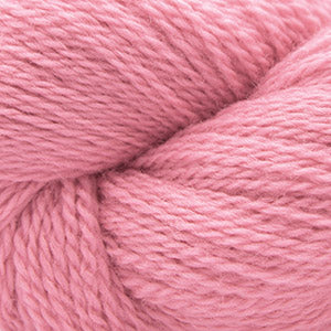 Close up on a light pink skein of Cascade 220 Fingering yarn.
