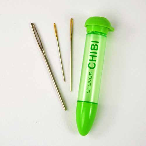 Set of 3 straight tapestry needles and a plastic container to hold them.