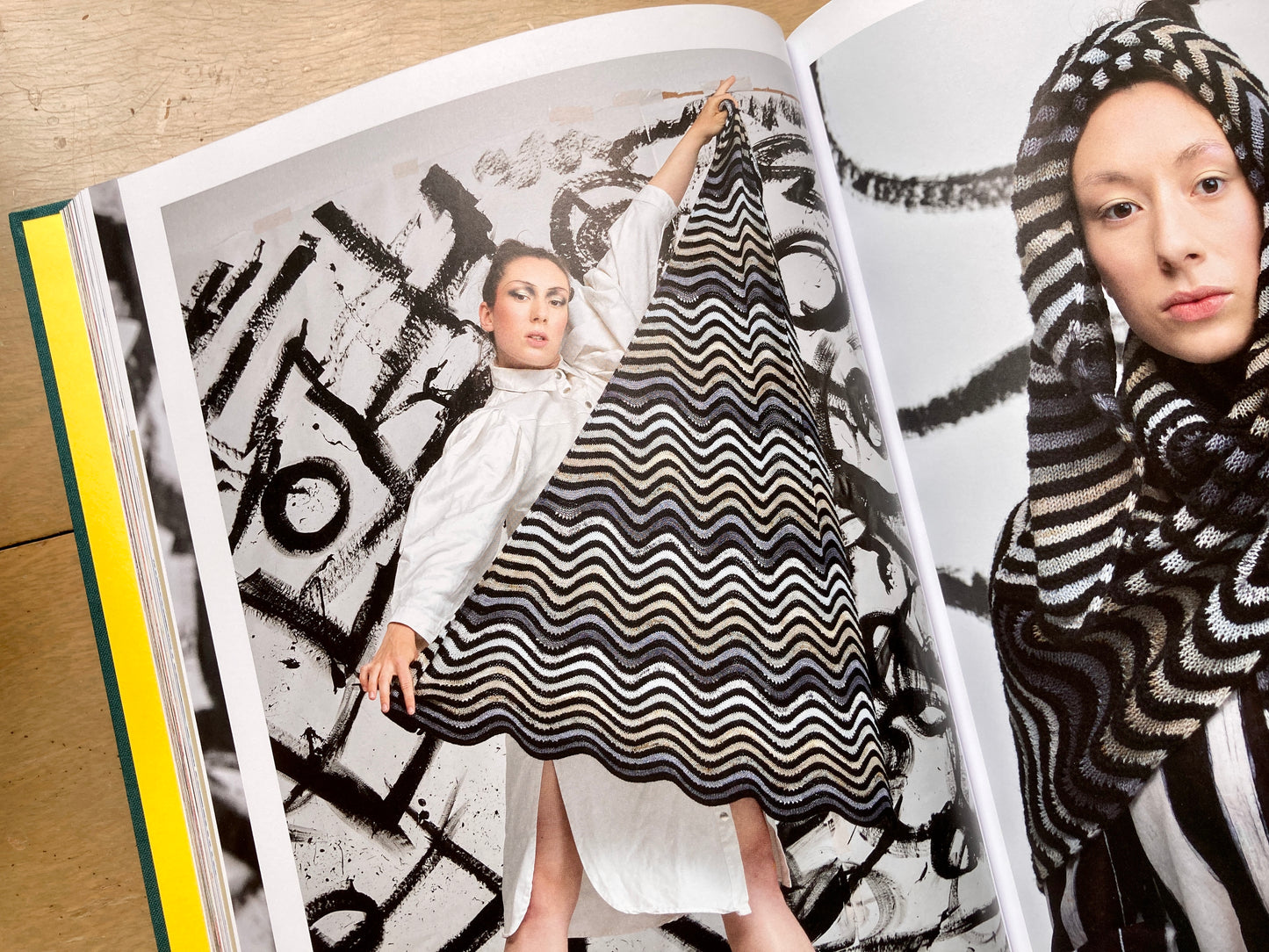 Stephen West’s Painting Shawls book, lying open, showing colorful photos of people modeling shawls.