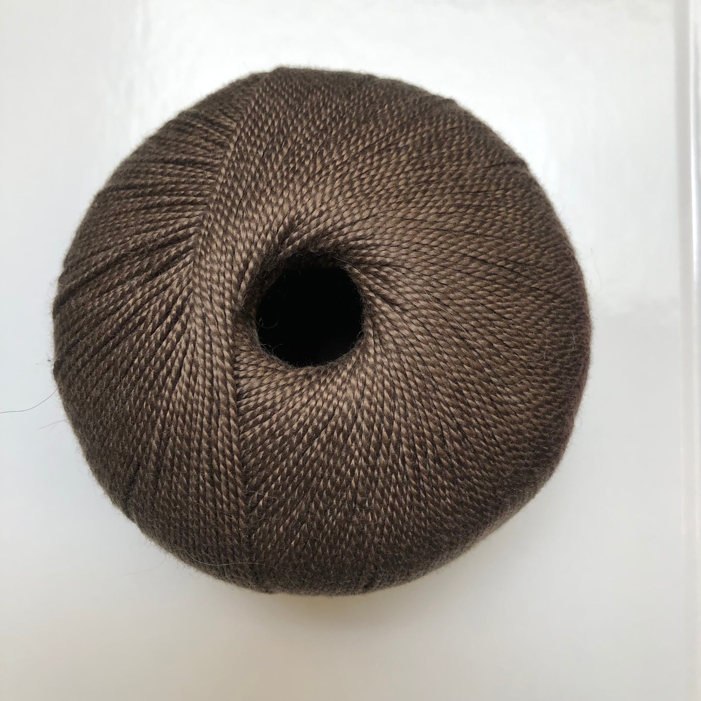 Ball of brown Isager Bomuld yarn.