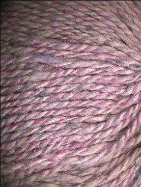 Close up on a light pink tweed ball of Queensland Kathmandu Aran yarn.
