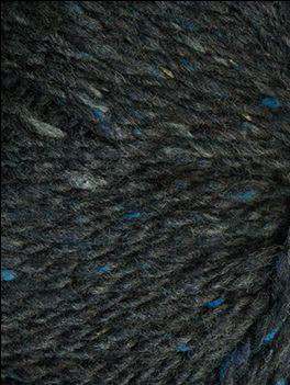 Close up on a dark indigo tweed ball of Queensland Kathmandu Aran yarn.