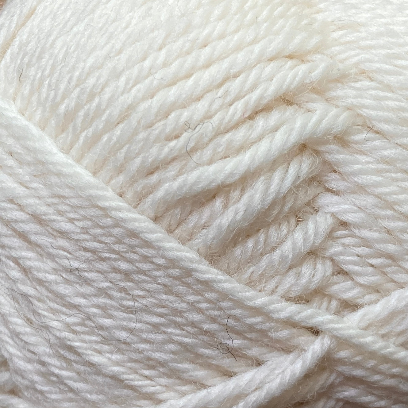 Close up on a white ball of Jo Sharp Classic Wool DK yarn.